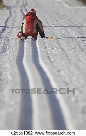 Stock Image - Day, Kneeling, Knit Hat, Non-Urban Scene. Fotosearch