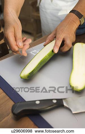 Stock Photo - Close-Up, Cucumber, Cutting, Cutting Board, Green. Fotosearch
