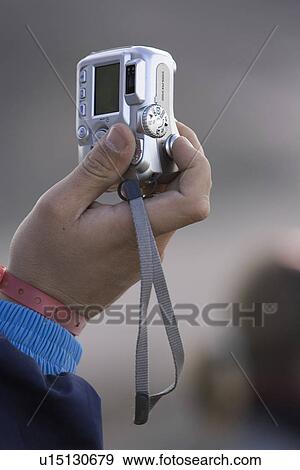 Close-Up, Digital Camera, Focus On Foreground, Holding View Large Photo Image Stock Photo - Close-Up, Digital Camera, Focus On Foreground, Holding. Fotosearch