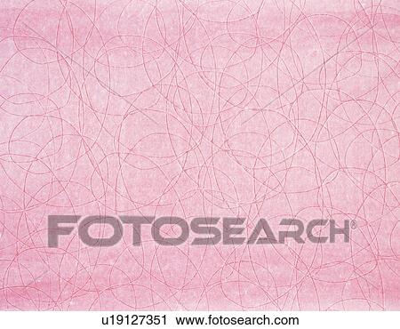 Stock Image - Japanese paper colored pink with oval patterns, close up. Fotosearch