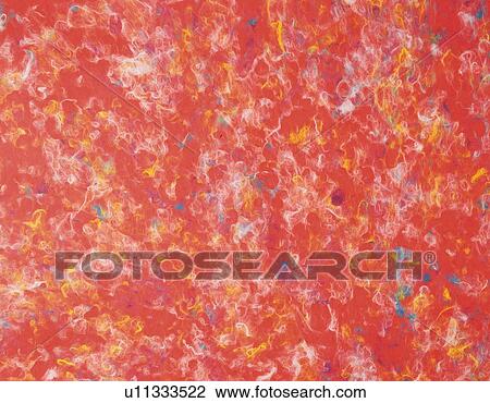 Stock Image - Japanese paper colored red with patterns in multicolor, close up. Fotosearch