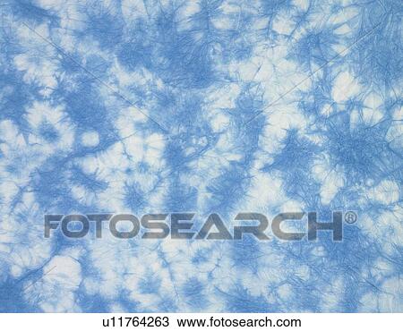 Stock Image - Japanese paper in blue and white marble pattern, close up. Fotosearch
