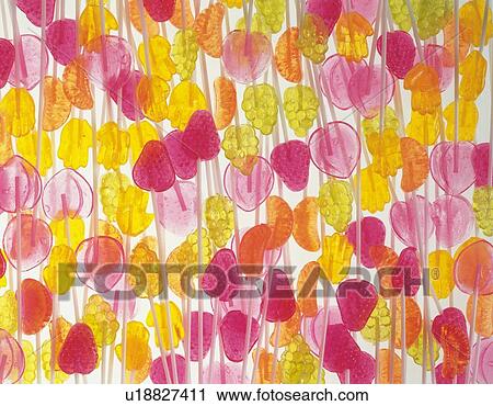 Mass of candies with sticks shaped like fruits View Large Photo Image Stock Image - Mass of candies with sticks shaped like fruits. Fotosearch