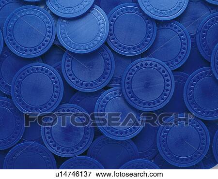 Mass of plastic coins in blue View Large Photo Image Stock Photo - Mass of plastic coins in blue. Fotosearch
