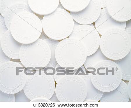 Mass of plastic coins in white View Large Photo Image Stock Photograph - Mass of plastic coins in white. Fotosearch