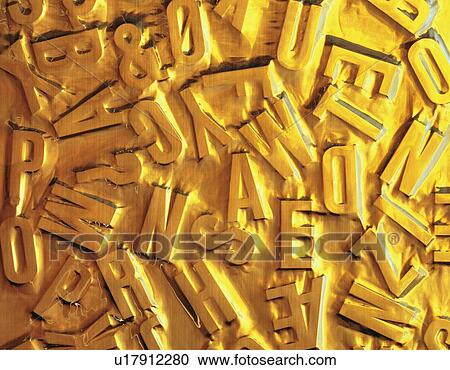 Stock Image - Objects shaped letters covered with gold liquid . Fotosearch