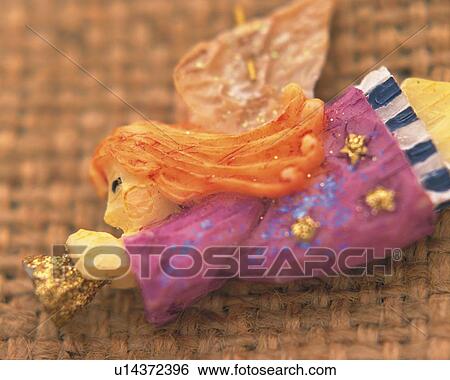 Stock Photograph - Angel Blowing Trumpet, Close Up, Differential Focus, In Focus, Out Focus. Fotosearch