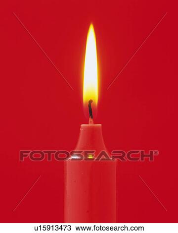 Stock Image - Red Burning Candle, Front View, Close Up. Fotosearch