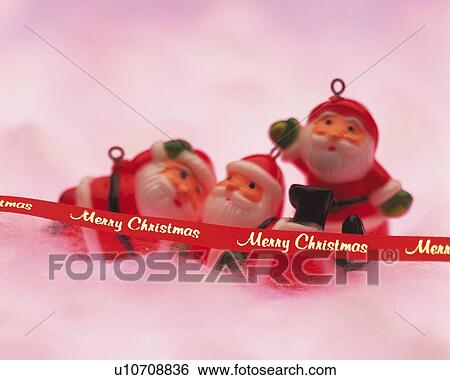 Stock Photograph - Three Santa Claus Figures, Close Up, Side View, Differential Focus, In Focus, Out Focus. Fotosearch