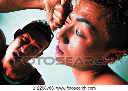 Stock Photograph - Two Young Adult Men Fighting, Photography, High Angle View, Toned Image. Fotosearch