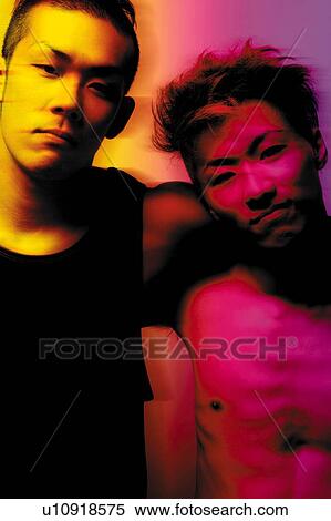 Stock Photography - Two Young Adult Men Looking at Camera, Photography, Front View, Toned Image. Fotosearch