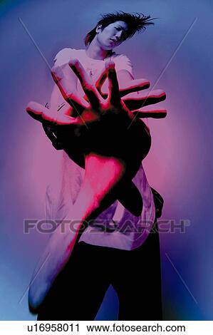 Stock Image - Young Adult Man Posing, Photography, CG, Low Angle View, Toned Image. Fotosearch