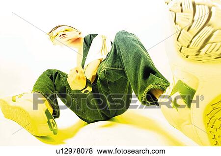 Stock Photo - Young Adult Man Posing, Photography, CG, Low Angle View, Toned Image. Fotosearch