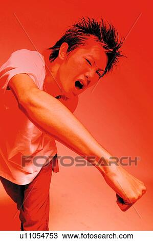 Young Adult Man Punching, Photography, Front View, Toned Image View Large Photo Image Stock Image - Young Adult Man Punching, Photography, Front View, Toned Image. Fotosearch