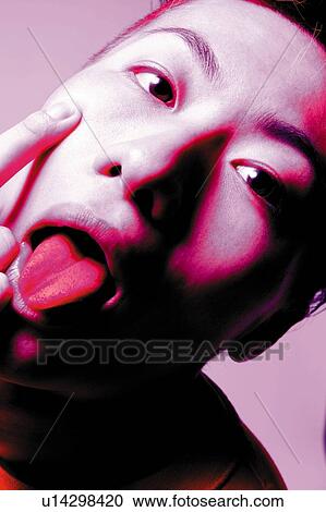 Young Adult Man Putting Out Tongue, Photography, CG, Close Up, High Angle View, Toned Image View Large Photo Image Stock Image - Young Adult Man Putting Out Tongue, Photography, CG, Close Up, High Angle View, Toned Image. Fotosearch