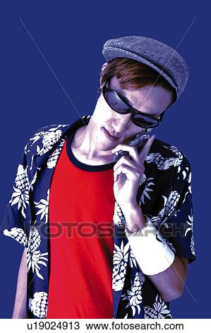Stock Image - Young Adult Man talking on Mobile Phone, Photography, Front View. Fotosearch