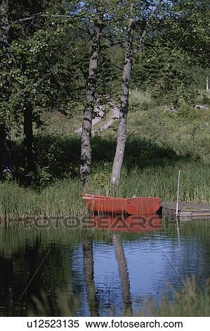 A Red Boat Reflecting On A Lake In Germany View Large Photo Image Stock Photography - A Red Boat Reflecting On A Lake In Germany. Fotosearch