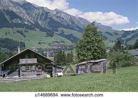Mountain Range And A House In The Alps In Switzerland View Large Photo Image Picture - Mountain Range And A House In The Alps In Switzerland. Fotosearch