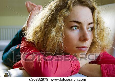 Stock Photo - background, blond, blouse, blurred, centrallong, couch, eyes. Fotosearch