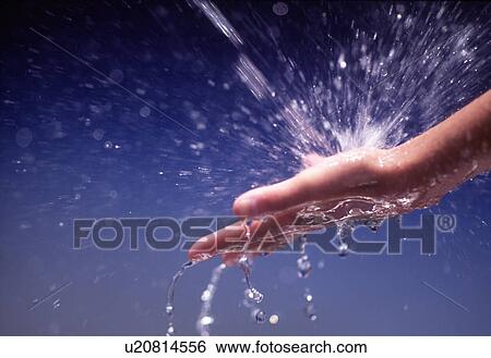 Close-up of water being poured on human hand View Large Photo Image Stock Photograph - Close-up of water being poured on human hand. Fotosearch