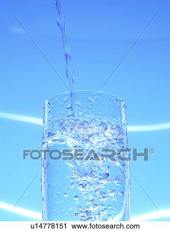 Low angle view of water being poured in glass View Large Photo Image Stock Image - Low angle view of water being poured in glass. Fotosearch