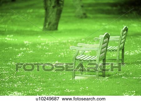 Side view of two wooden chairs in a park View Large Photo Image Stock Photo - Side view of two wooden chairs in a park. Fotosearch