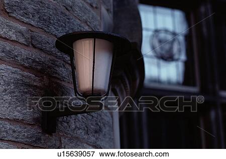 Stock Photo - Street Lamp On Stone Wall. Fotosearch