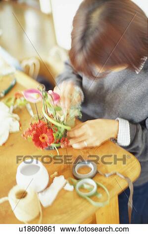A young adult woman arranging flower View Large Photo Image Stock Image - A young adult woman arranging flower. Fotosearch