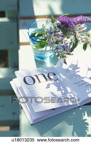 Book and flower bouquet in glass at table View Large Photo Image Stock Photography - Book and flower bouquet in glass at table. Fotosearch