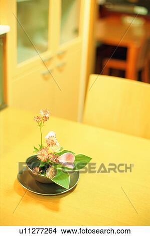 Flower arrangement on dining table Picture | u11277264 | Fotosearch