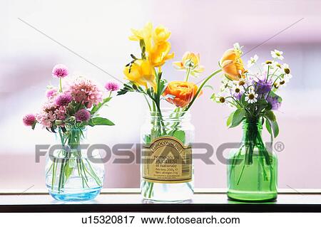 Stock Photo - Three vases with flowers. Fotosearch