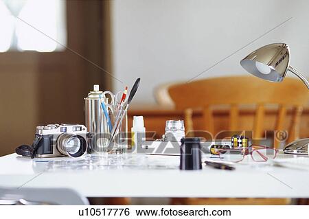 Stock Photograph - Camera and stationeries on table. Fotosearch