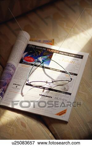 Magazine and glasses View Large Photo Image Stock Photo - Magazine and glasses. Fotosearch
