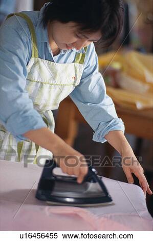 Mid adult woman ironing View Large Photo Image Stock Photography - Mid adult woman ironing. Fotosearch