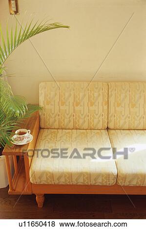 Stock Photo - Tea cup on sofa. Fotosearch