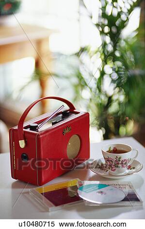 Tea cup, radio and CDs on table View Large Photo Image Stock Photography - Tea cup, radio and CDs on table. Fotosearch