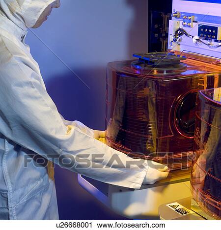 Stock Image - A lab technician working in a laboratory. Fotosearch