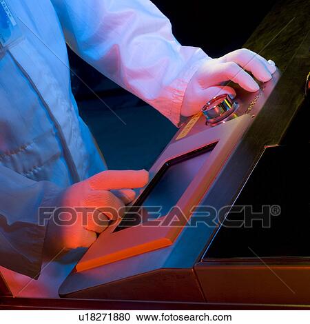 A technician in white lab suit working on a touch screen in laboratory View Large Photo Image Stock Image - A technician in white lab suit working on a touch screen in laboratory. Fotosearch