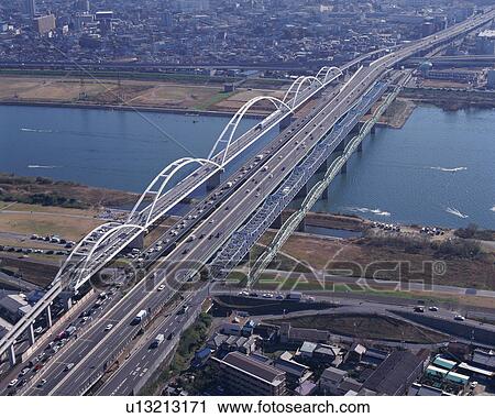 Stock Image - Aerial view of a spectacular architectural bridge over the river. Fotosearch