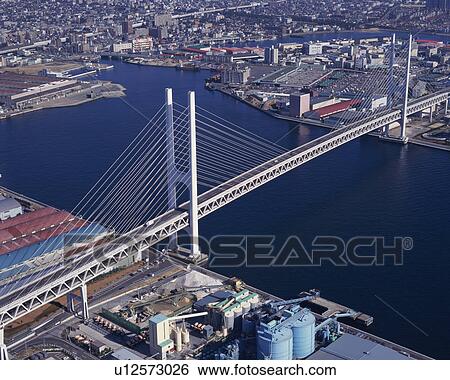 Stock Photograph - Aerial view of a spectacular architectural bridge over the river. Fotosearch