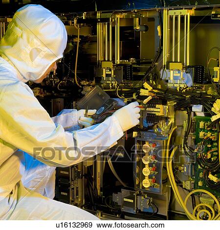 Stock Photo - An engineer testing electronic devices. Fotosearch