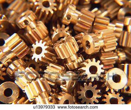 Stock Image - Close up of large group of metallic gears. Fotosearch