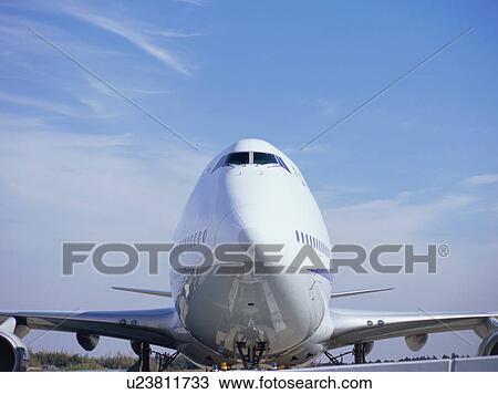 Stock Image - Front view of a huge plane on the runway. Fotosearch