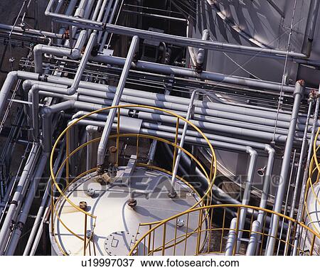Stock Photo - High angle view of railings and pipes in an industrial plant. Fotosearch