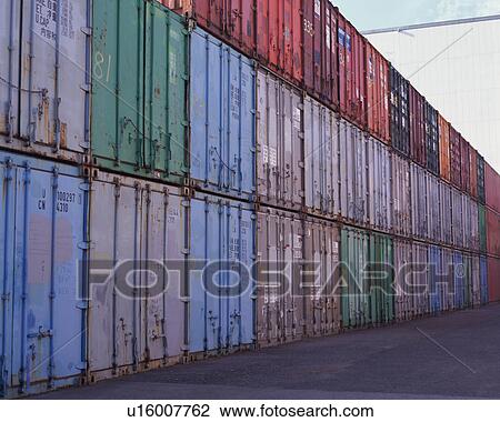 Stock Image - Huge containers arranged over each other at dock. Fotosearch