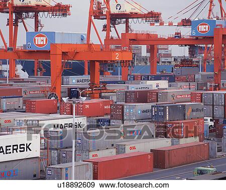 Stock Photo - Huge cranes and containers at dock. Fotosearch