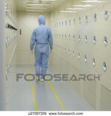 Stock Photography - Rear view of one person in white lab suit walking in corridor. Fotosearch