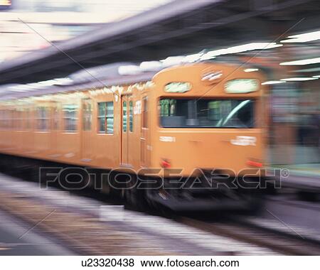 Stock Photo - Side view of electric train at station. Fotosearch