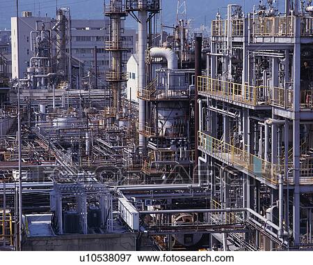 Stock Photo - Side view of railings and pipes in an industrial plant. Fotosearch