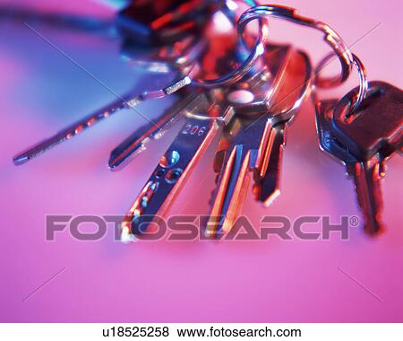 Stock Photo - Bunch of keys placed on a pink surface. Fotosearch